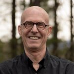 Philosophy professor Dr. Todd May stands and smiles for a picture