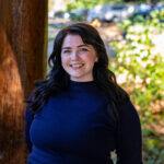 WWC professor, Dr. Kaela Thuney stands and smiles for a portrait